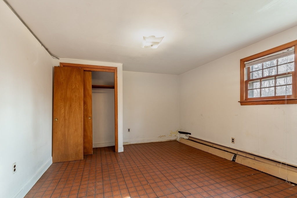 51 Eldred Street Lexington, MA 02420 - Photo 23 of 30 an empty room with wooden floor and windows