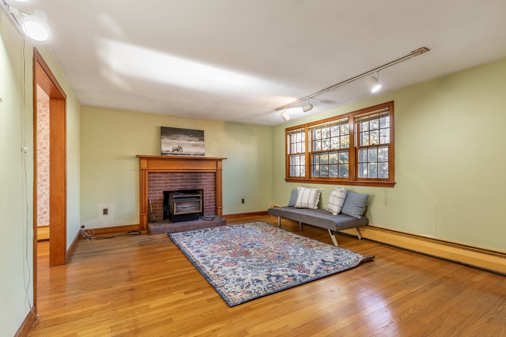 51 Eldred Street Lexington, MA 02420 - Photo 5 of 30 a living room with furniture and a fireplace