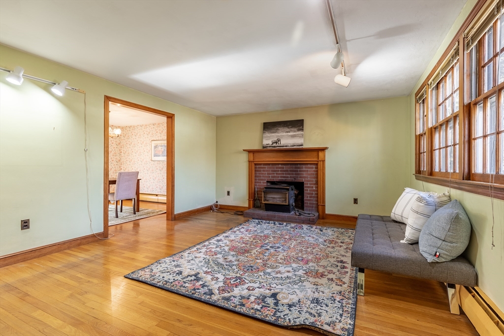 51 Eldred Street Lexington, MA 02420 - Photo 6 of 30 a living room with furniture and a fireplace