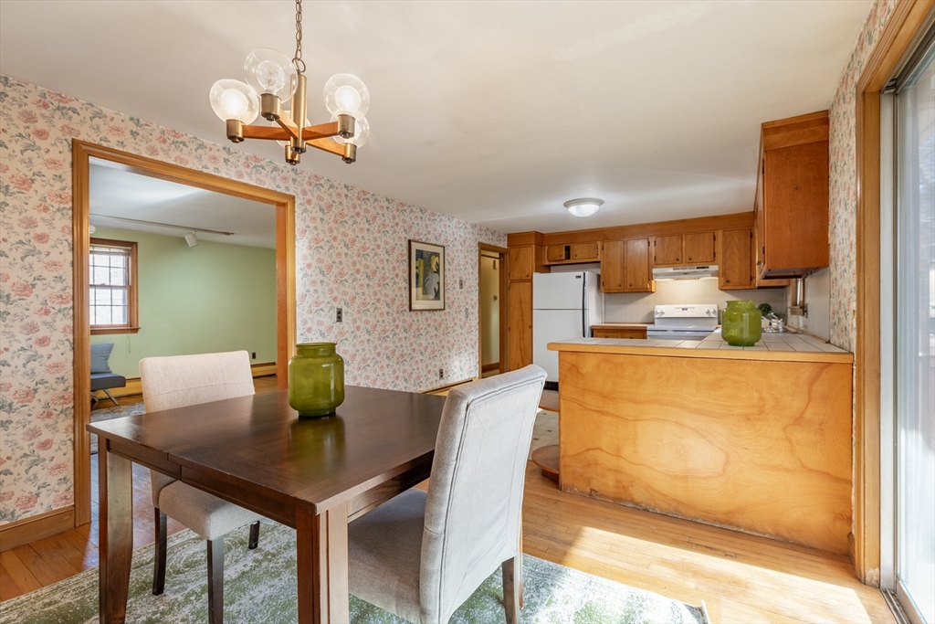 51 Eldred Street Lexington, MA 02420 - Photo 10 of 30 a dining room with stainless steel appliances a table and chairs