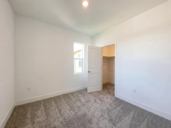 an empty room with windows and closet