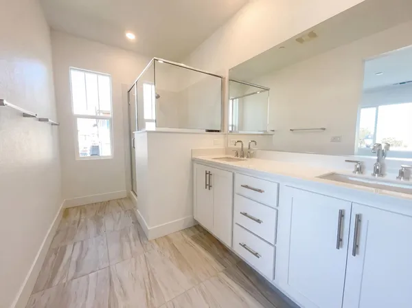a spacious bathroom with a sink mirror and a shower