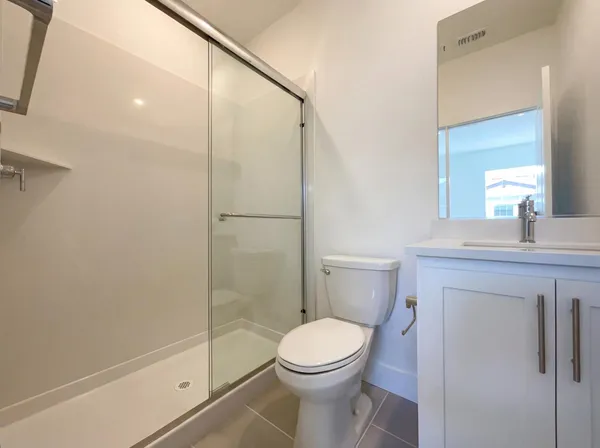 a bathroom with a toilet a sink and shower