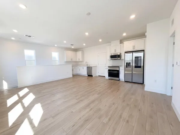 a view of a kitchen with a sink and a stove top oven