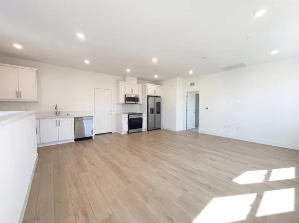 a view of kitchen with refrigerator and window