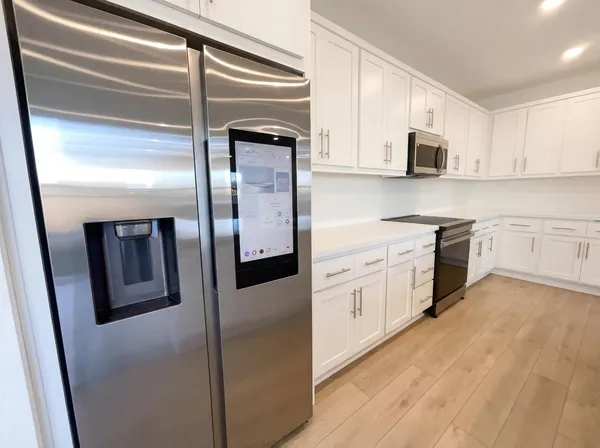 a kitchen with stainless steel appliances cabinets and a counter top space