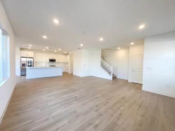 a view of a kitchen with a sink and a refrigerator