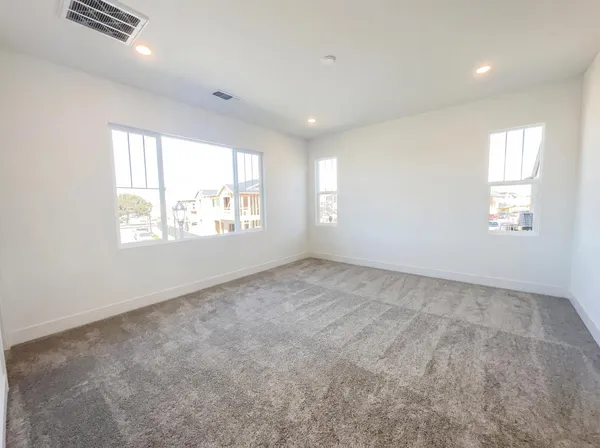 a view of an empty room and a window