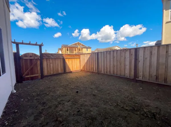 a kitchen with chandelier fan and wooden floor