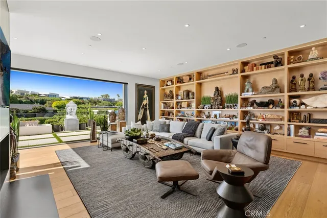 a living room with fireplace furniture and a large window