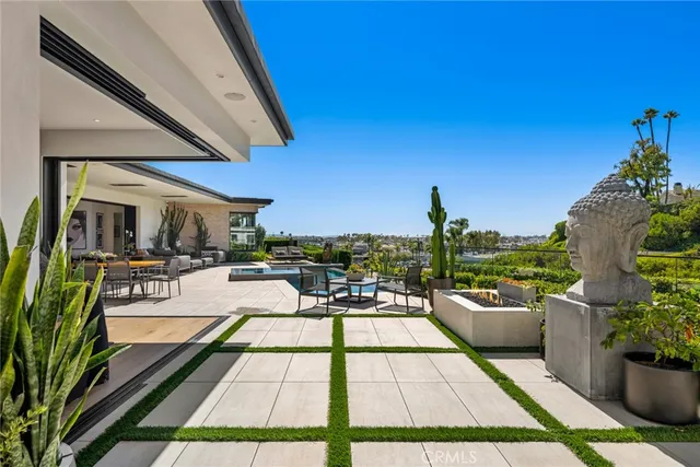 a view of a patio with chairs potted plants and a palm tree