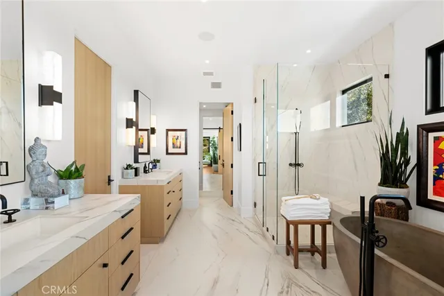 a living room with furniture a potted plant and a painting on the wall