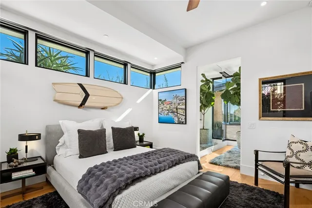 a bedroom with bed and a potted plant