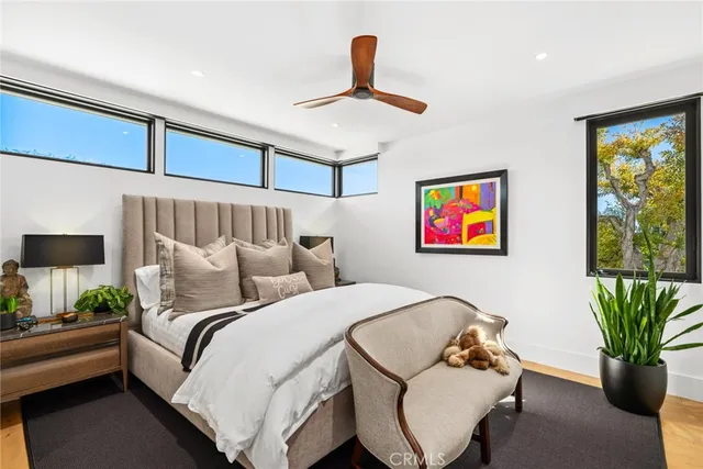 a bedroom with a bed a couch and a window