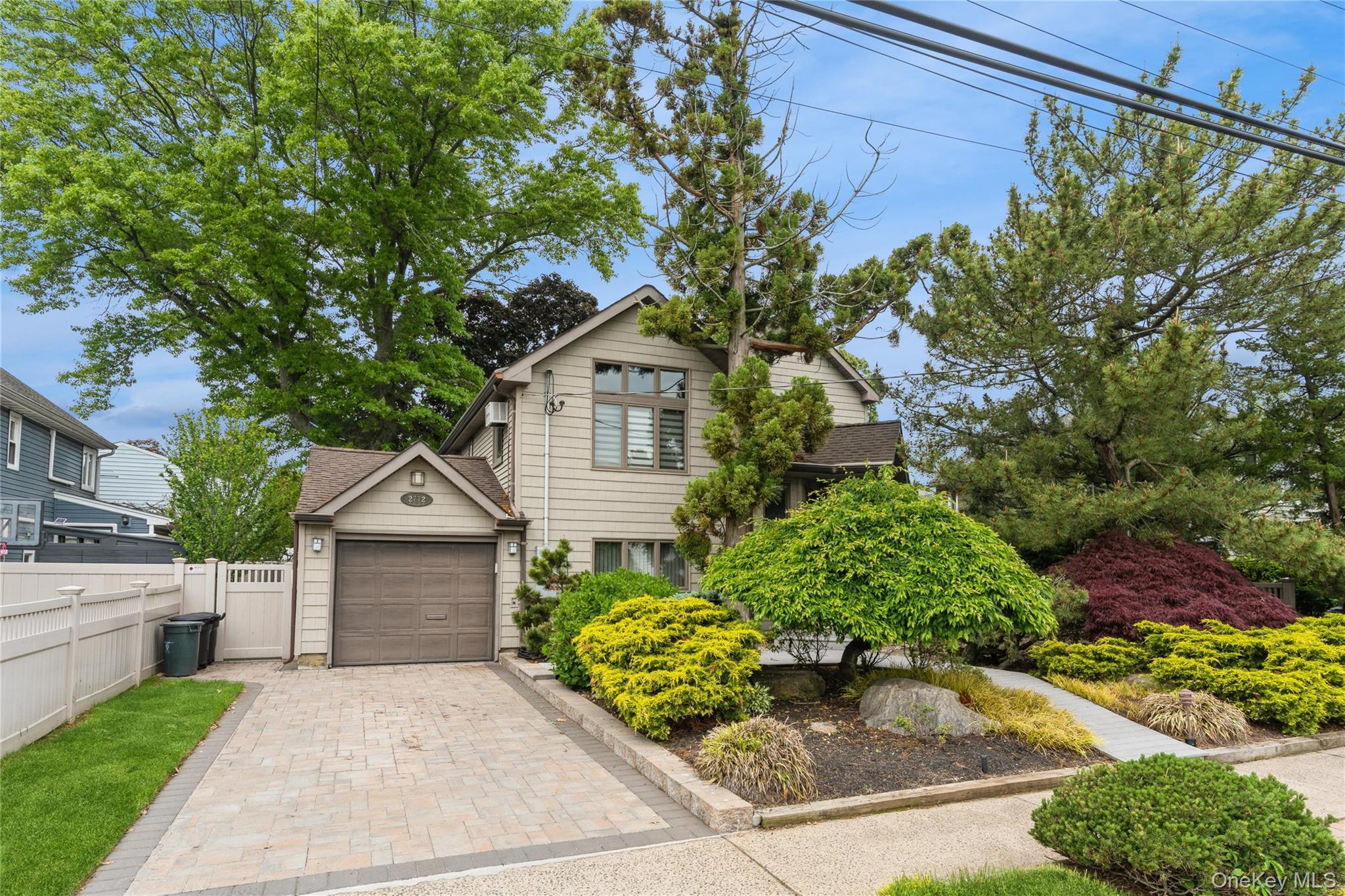 2772 Riverside Avenue Merrick, NY 11566 - Photo 45 of 45 a front view of a house with a garden