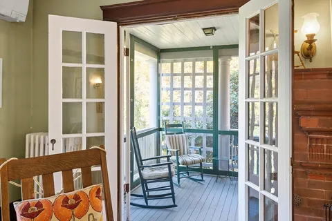 a view of a bedroom with furniture and a window