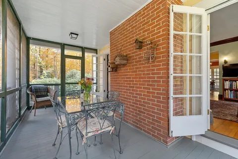 a view of a dining room with furniture and a window