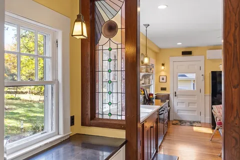 a kitchen with a table chairs stove and refrigerator