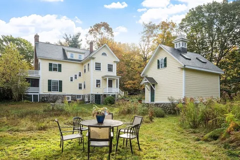 a view of a house with swimming pool and sitting area
