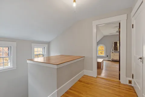 a view of entryway and hall with wooden floor