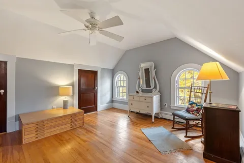 a view of a room with wooden floor staircase and windows