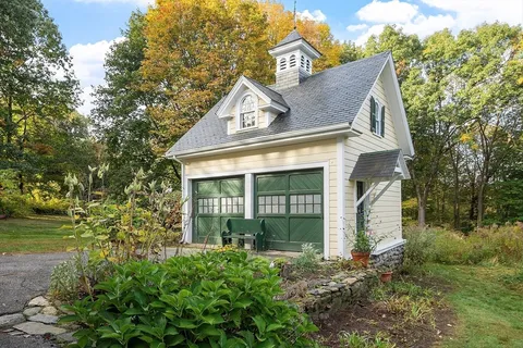 an aerial view of house with yard swimming pool and outdoor seating