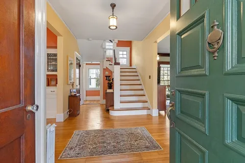 a view of entryway and hall with wooden floor