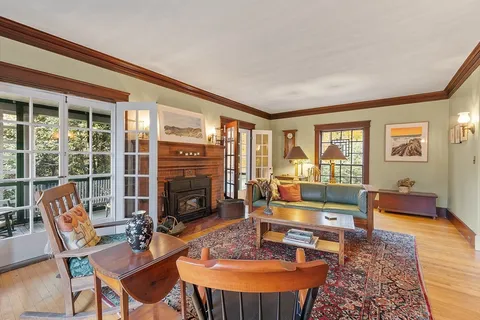 a living room with furniture a fireplace and a table