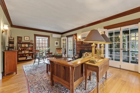 a livingroom with furniture wooden floor and a fireplace