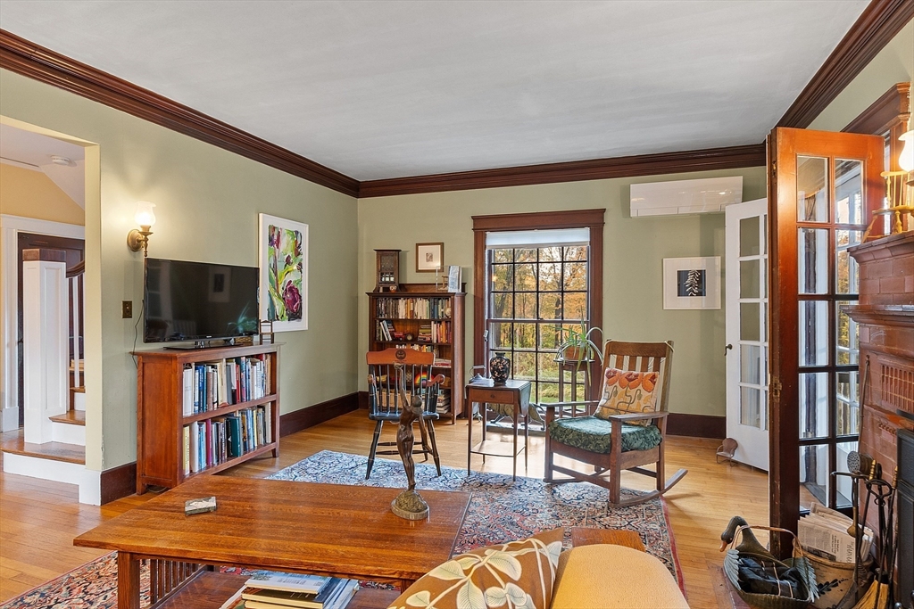 4 Bolton Road Harvard, MA 01451 - Photo 10 of 42 a living room with furniture a flat screen tv and a bookshelf