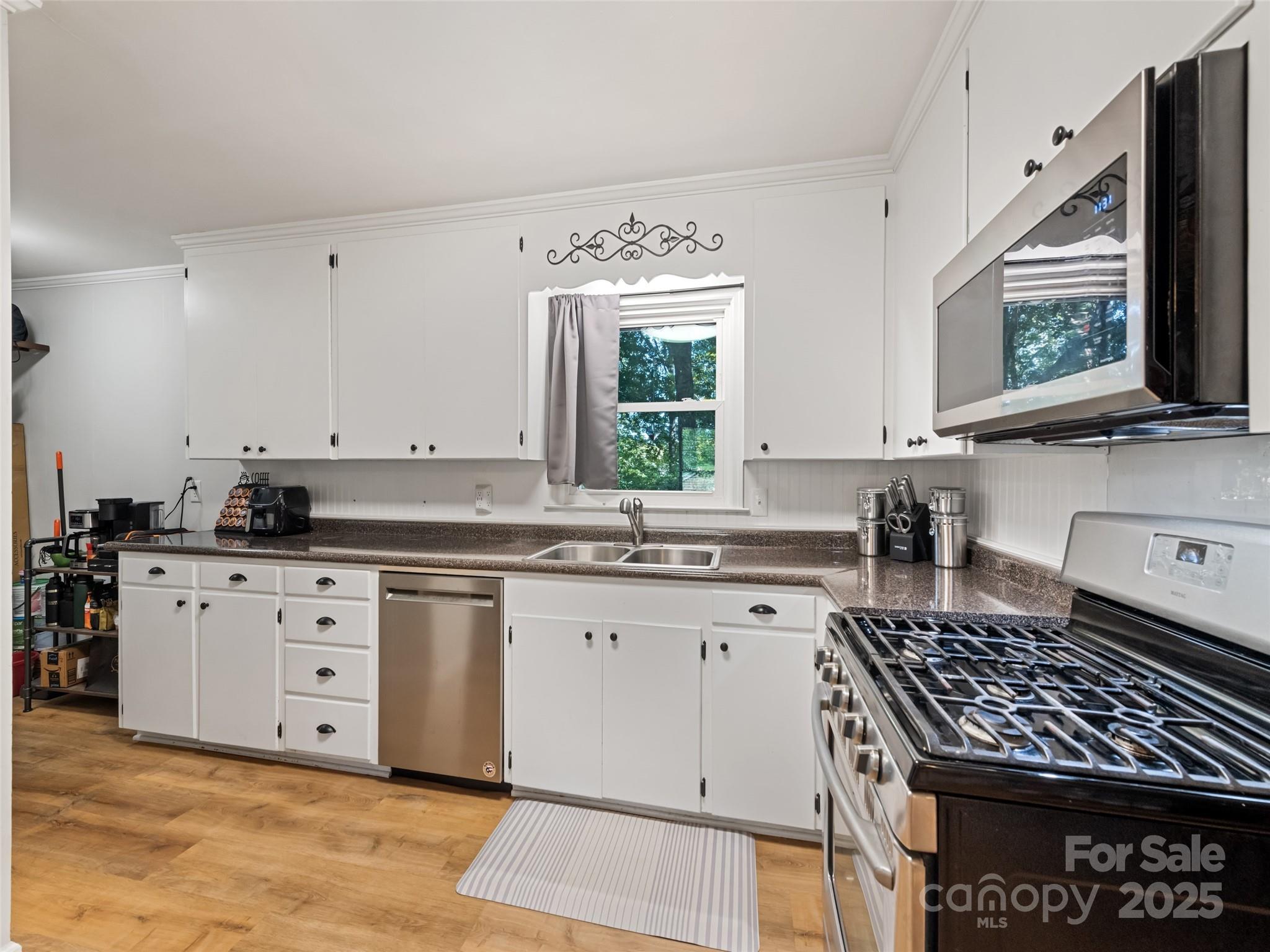 263 Blanton Street Columbus, NC 28722 - Photo 14 of 45 a kitchen with stainless steel appliances granite countertop a stove a sink and a microwave