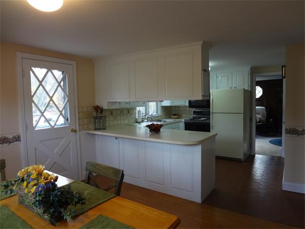 25 Bennett Road Marblehead, MA 01945 - Photo 4 of 15 a kitchen with stainless steel appliances kitchen island granite countertop a refrigerator and a sink