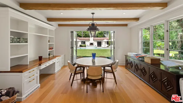 a dining room with furniture and wooden floor
