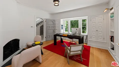 a view of a workspace with furniture and a window