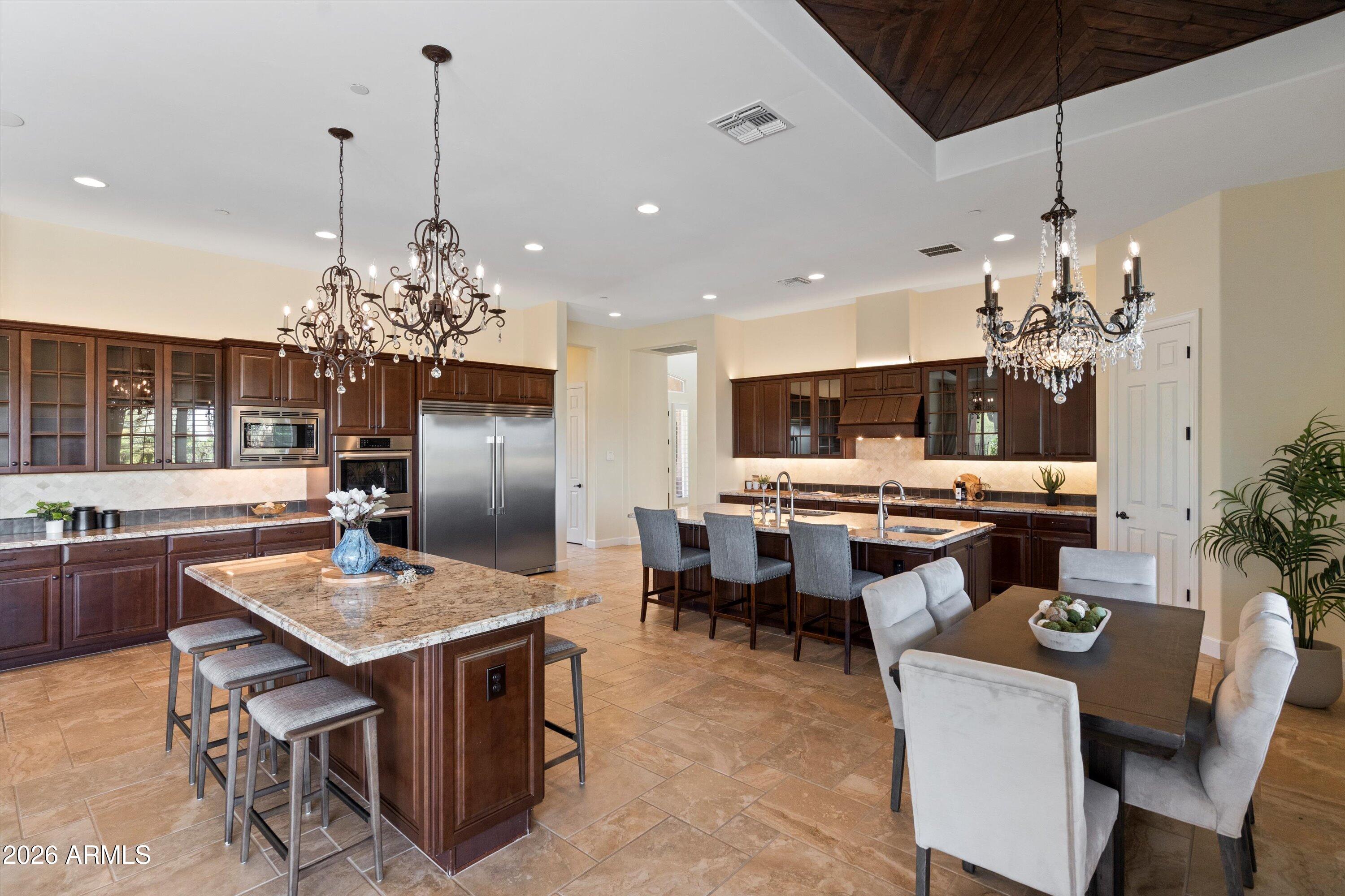 4602 East Mockingbird Lane Phoenix, AZ 85028 - Photo 12 of 41 a kitchen with a dining table and chairs
