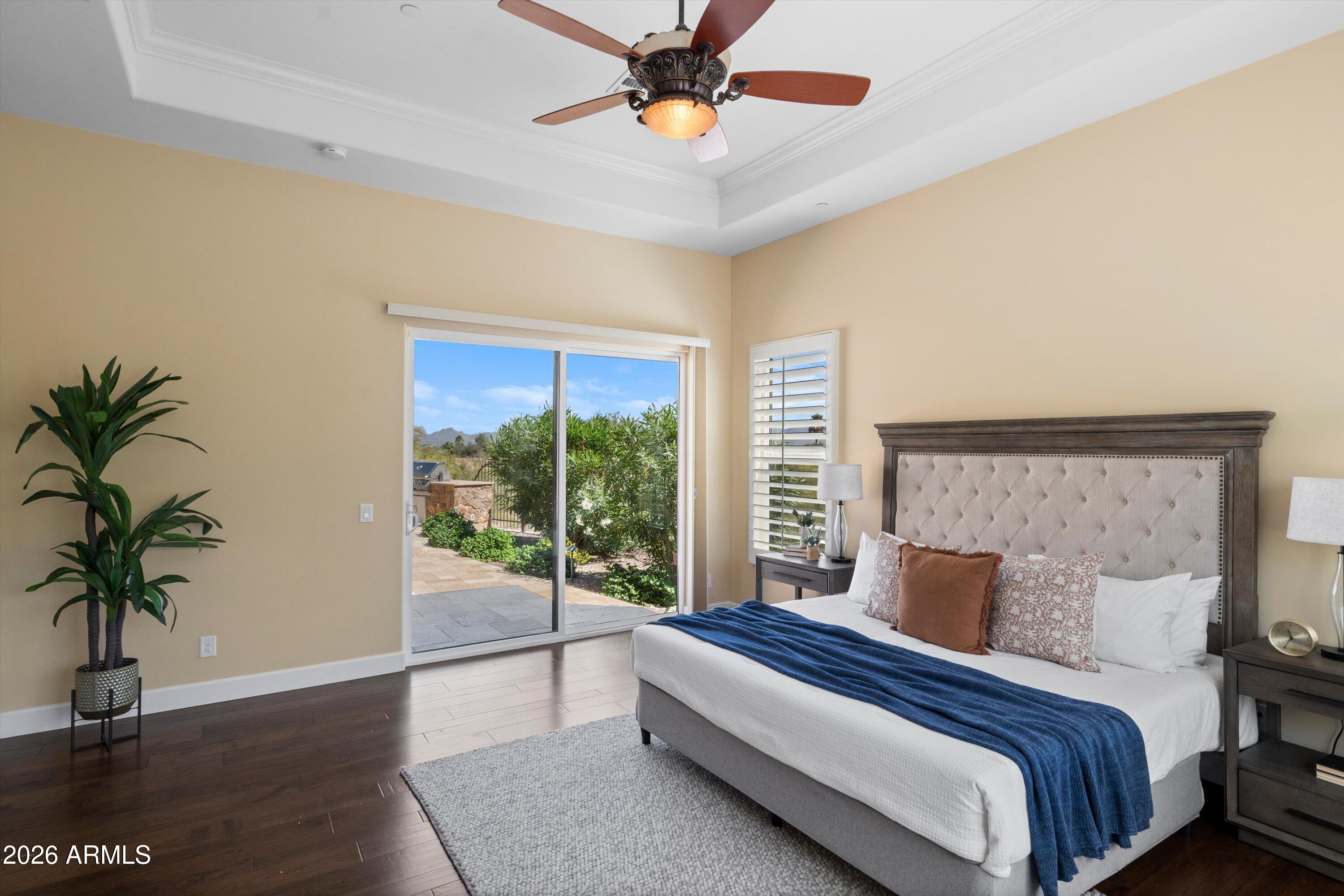4602 East Mockingbird Lane Phoenix, AZ 85028 - Photo 19 of 41 a bedroom with a large bed and a potted plant