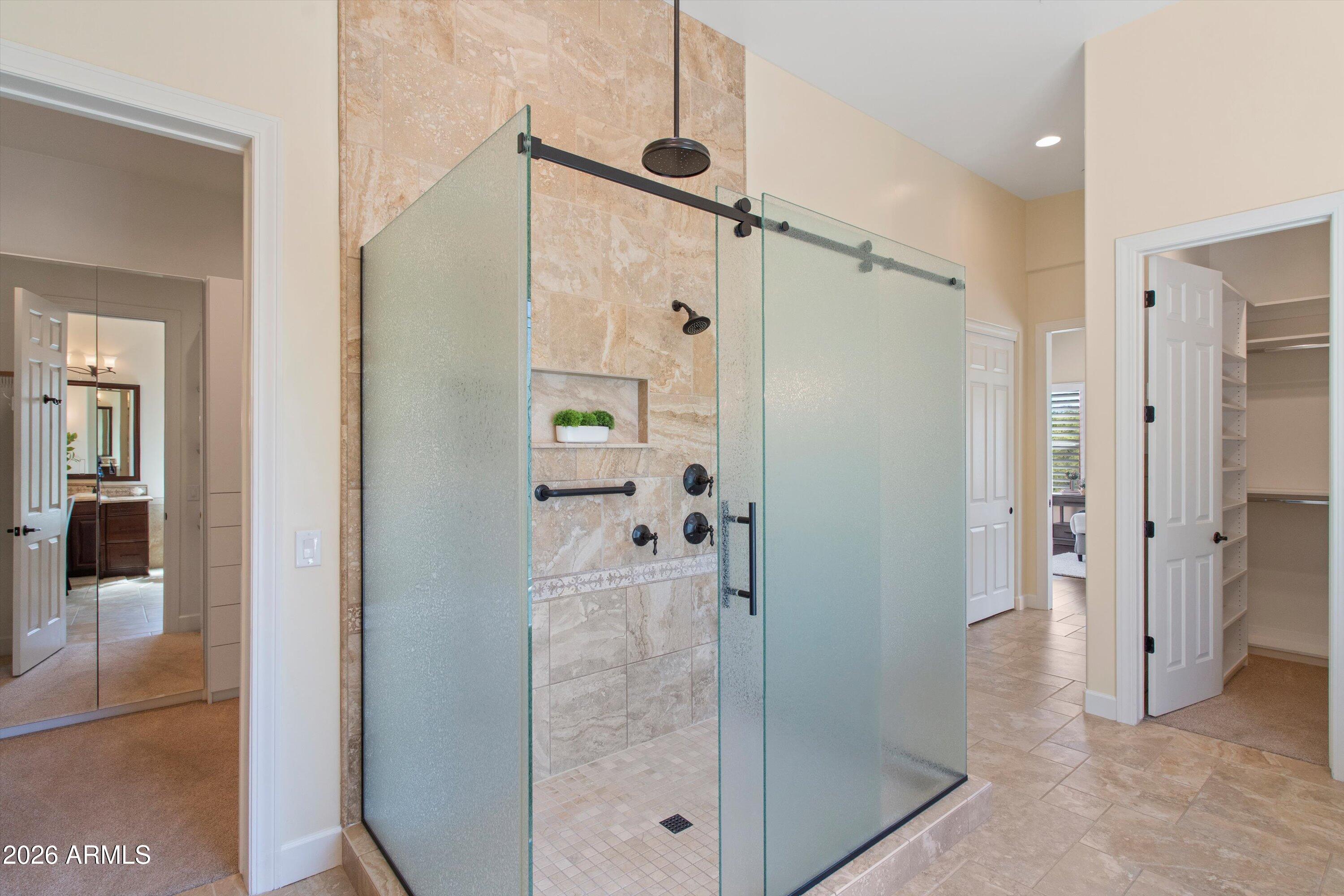 4602 East Mockingbird Lane Phoenix, AZ 85028 - Photo 22 of 41 a bathroom with a glass shower door and a glass door