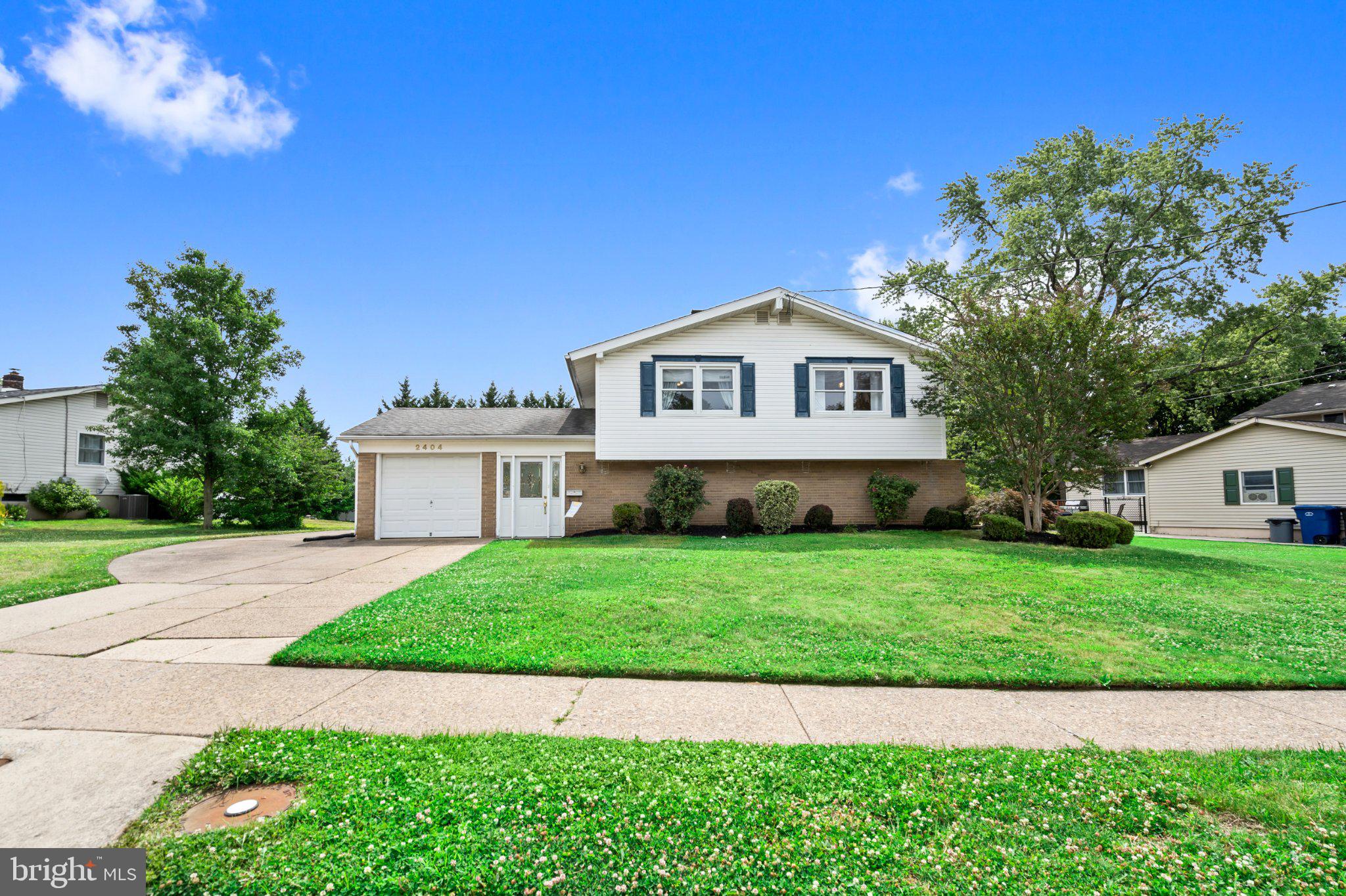 Charming home with lush green lawn.