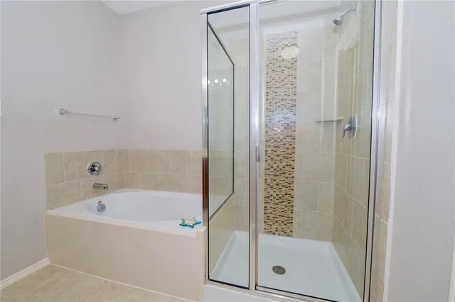 a bathroom with a bathtub and a shower