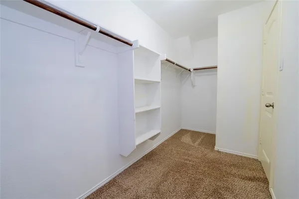 a view of an empty walk in closet
