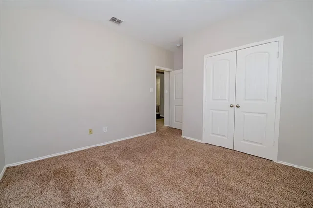 a view of an empty room and a window