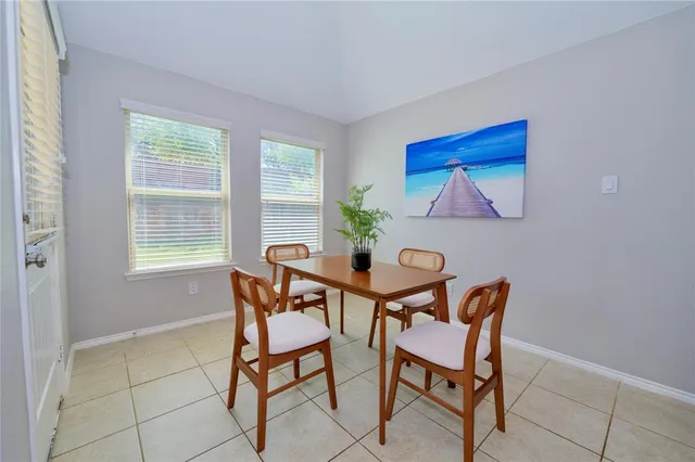 a view of a dining room with furniture and window