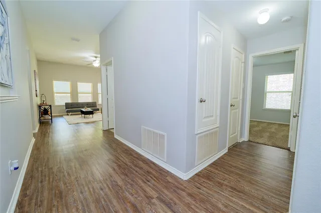 a view of a hallway view with wooden floor and furniture
