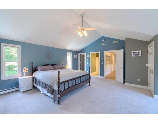 21 Indian Ridge Road Stow, MA 01775 - Photo 17 of 30 a spacious bedroom with a bed chandelier and a window