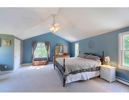 21 Indian Ridge Road Stow, MA 01775 - Photo 18 of 30 a spacious bedroom with a bed couch and window