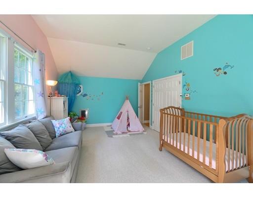 21 Indian Ridge Road Stow, MA 01775 - Photo 20 of 30 a living room with furniture and a baby crib