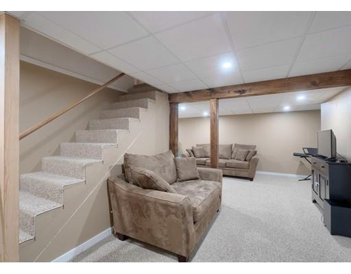 21 Indian Ridge Road Stow, MA 01775 - Photo 26 of 30 a living room with furniture and a flat screen tv