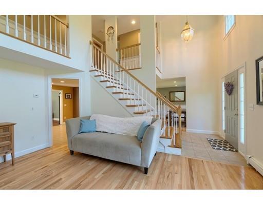 21 Indian Ridge Road Stow, MA 01775 - Photo 3 of 30 a living room with couches and a dining table with wooden floor