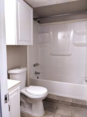 a bathroom with a toilet a sink and shower