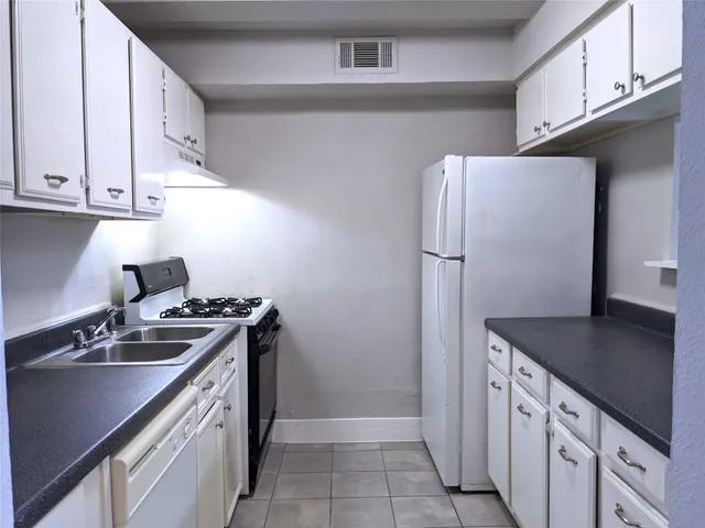 a kitchen with a sink stove and refrigerator